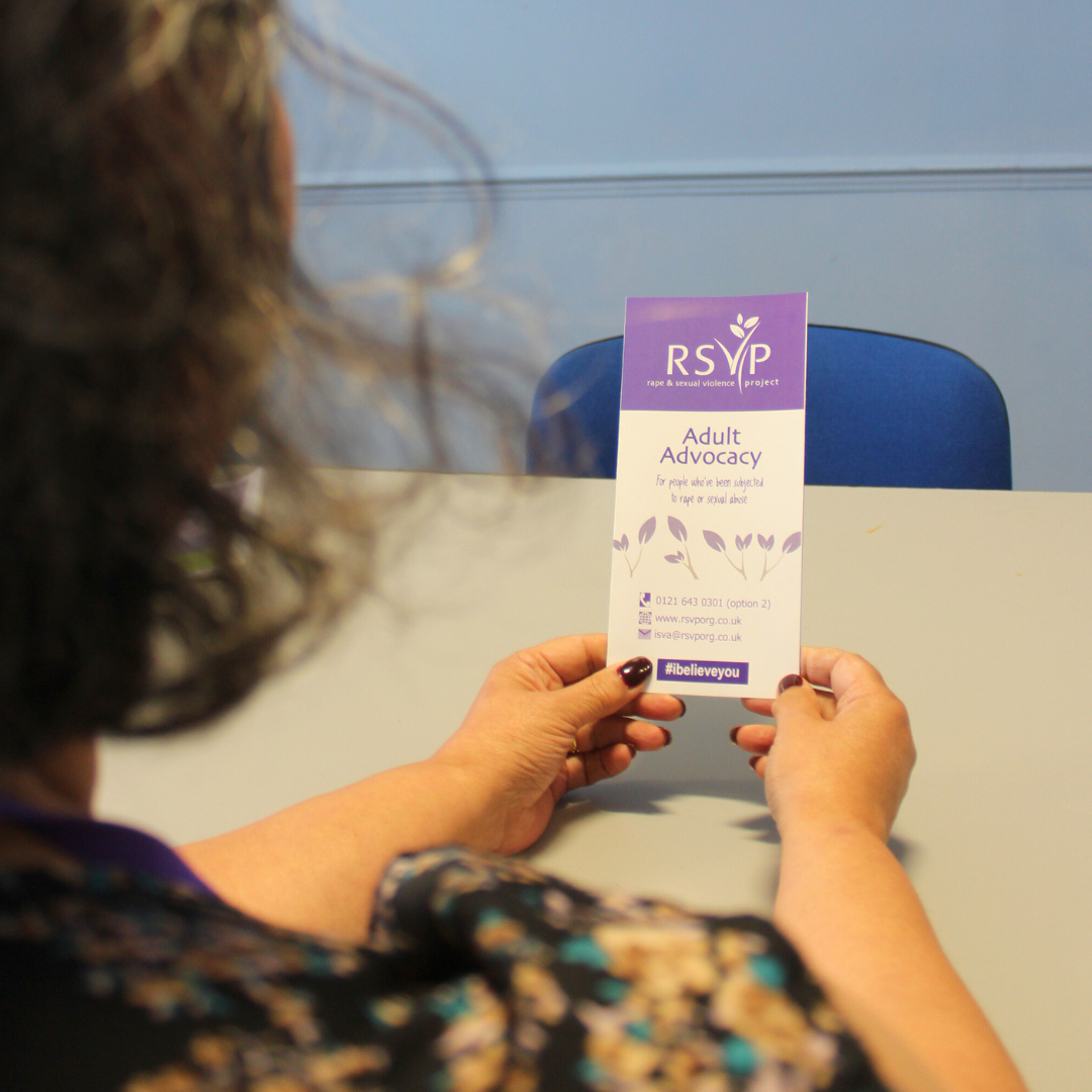 A person holding informational leaflet